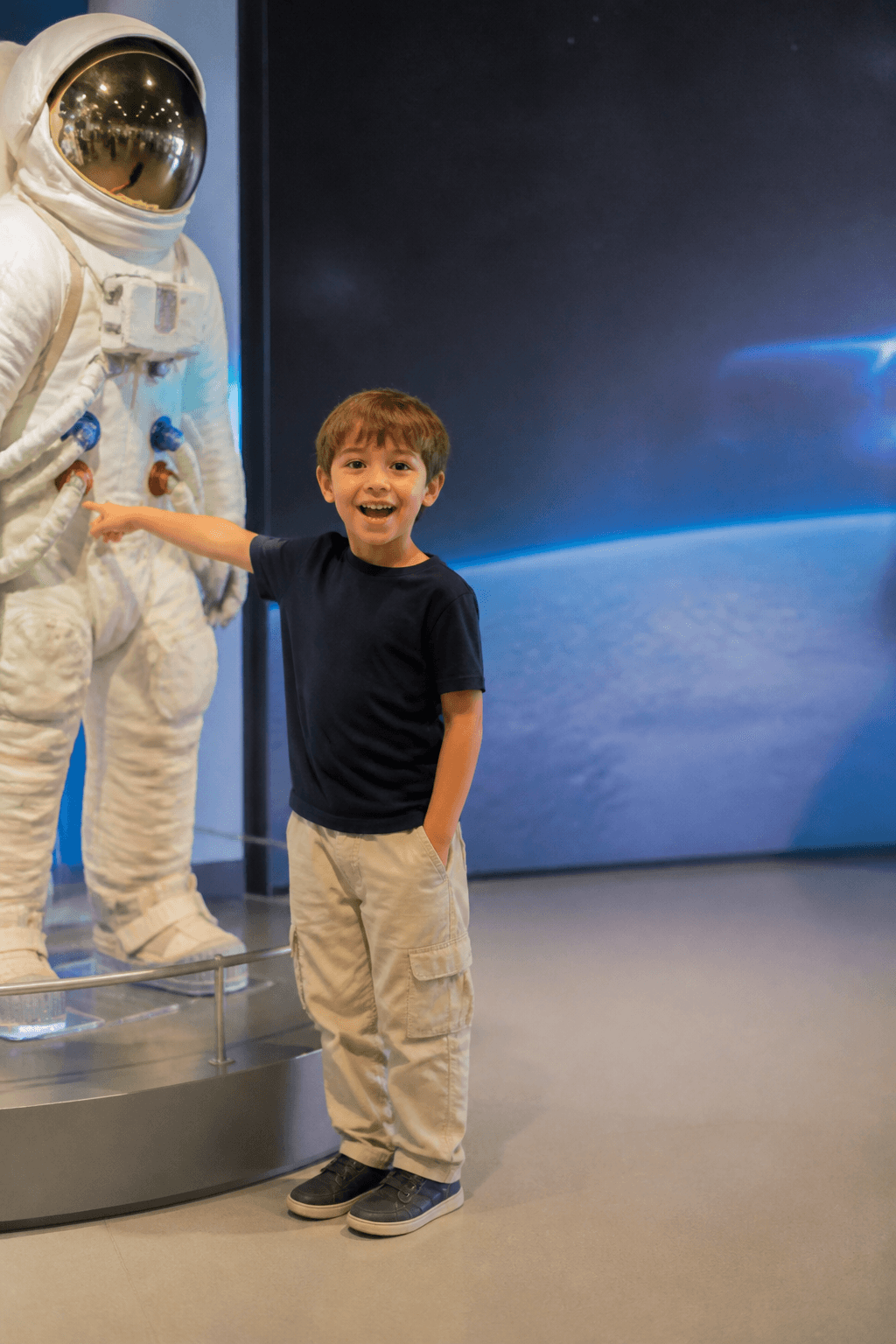 Child pointing at an astronaut exhibit before the prompt edit